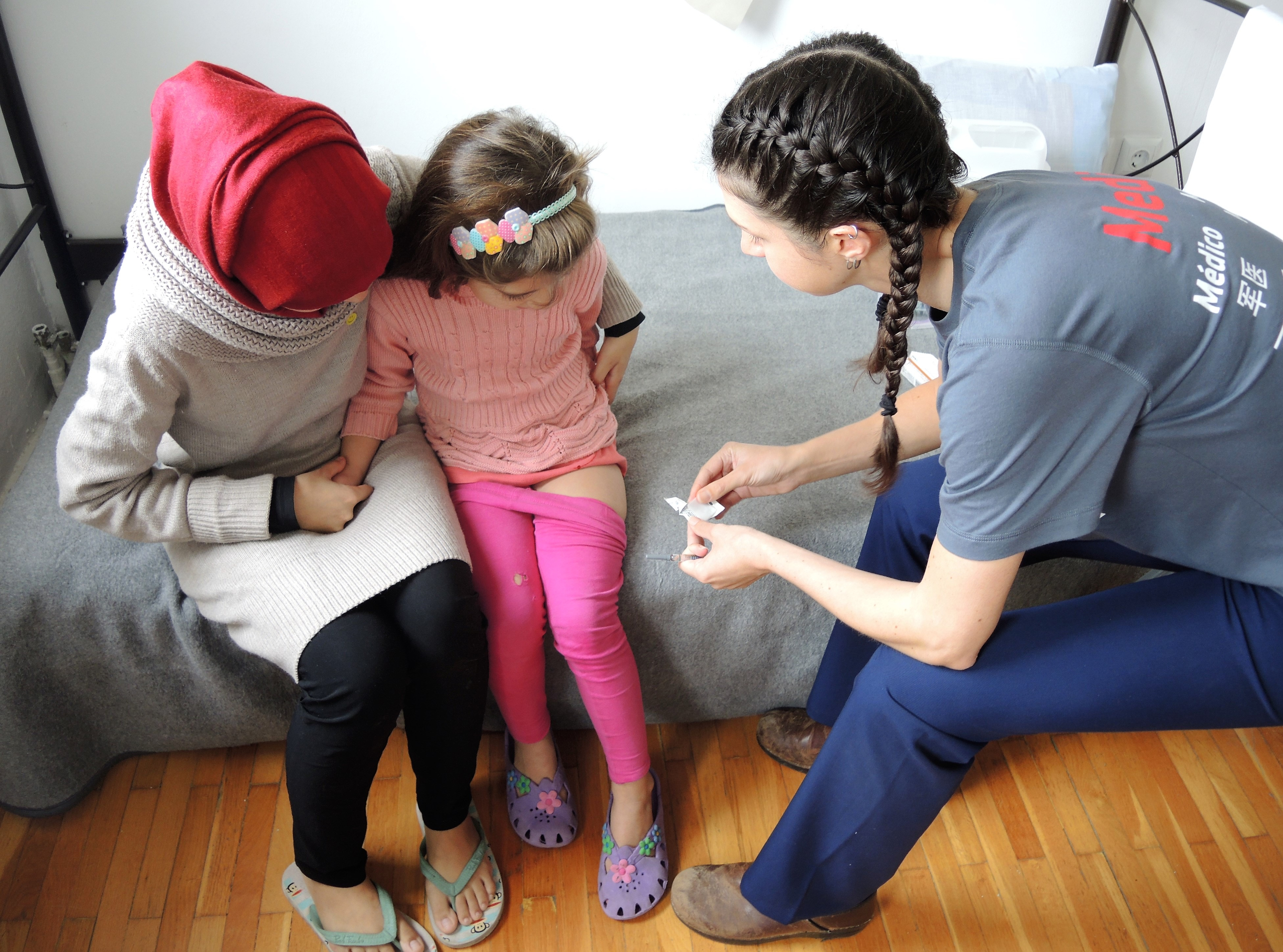 Immunizing a child in Greece who was born after the war in Syria began